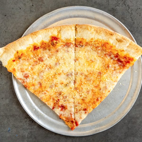 Two large slices of cheese pizza with red sauce and parmesan on a metal tray.